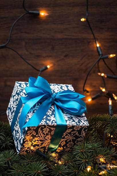 istock Christmas gift box with blue bow and lights 544446560