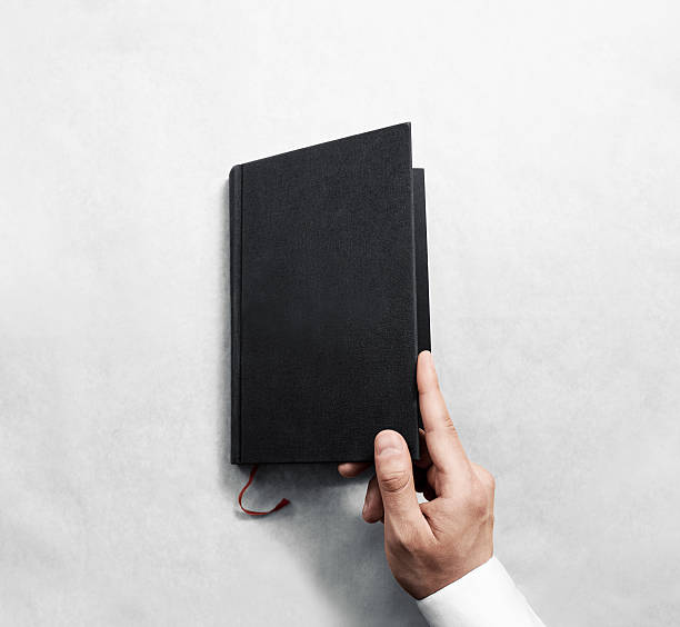 istock Hand opening blank black book cover mockup template. 544446750