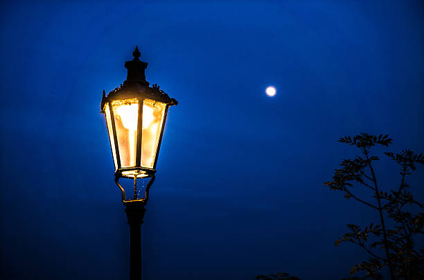 istock old street lamp against full moon night 544446878