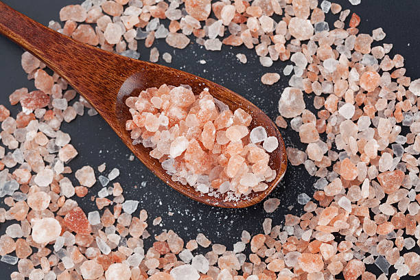 istock Himalayan pink rock salt in wooden spoon top view 544448520