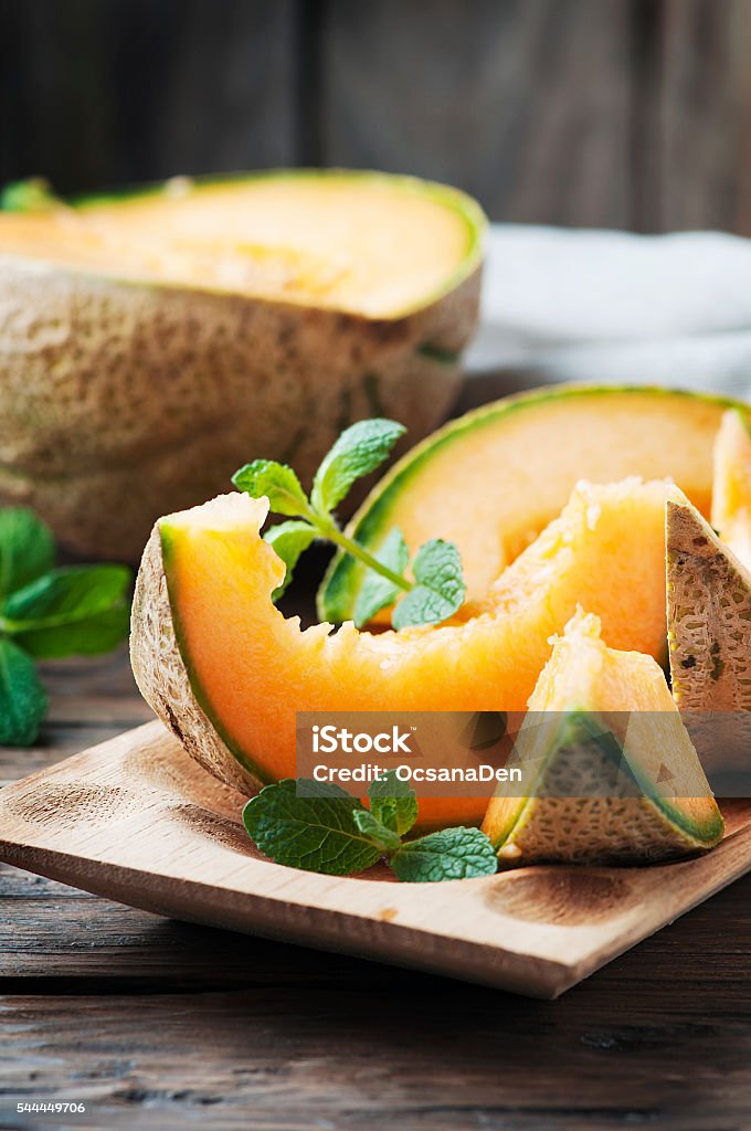 Fresh sweet orange melon and mint Fresh sweet orange melon and mint, selective focus Cantaloupe Stock Photo