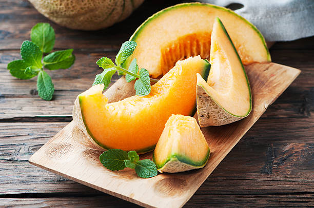 fresh sweet orange melon and green mint - melon imagens e fotografias de stock