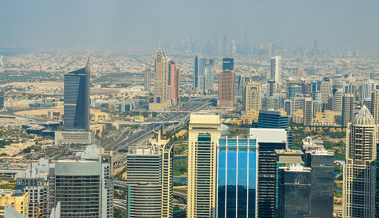 Business Dubai Marina skyscrapers on sunny day in UAE