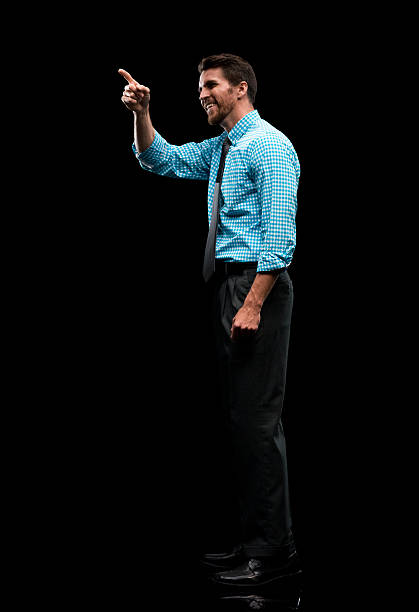 istock Smiling businessman pointing away 544454332