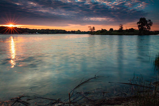 Lake landscape with beautiful sky at sunrise photographed on long exposure.