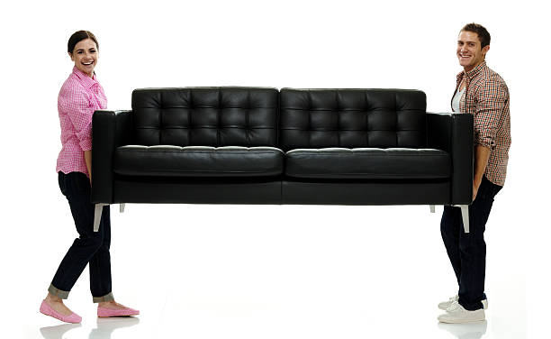 a double blue couch sofa on a blank wall in a living room