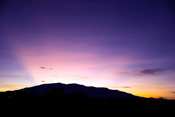 purple light sun on evening time after mountain