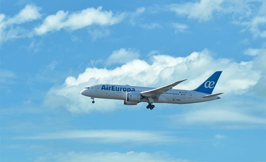 Palma, Mallorca - April 12, 2016: airplane of Air Europa flying in clouds. Its landing at the airport Palma de Mallorca, Spain. AirEuropa is a spanish airline with the base in Palma de Mallorca. The airplane has the registration EC-MIG