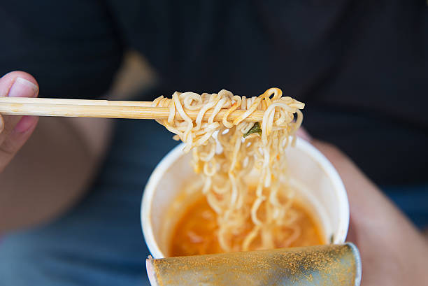 Man's hand instant noodles. stock photo