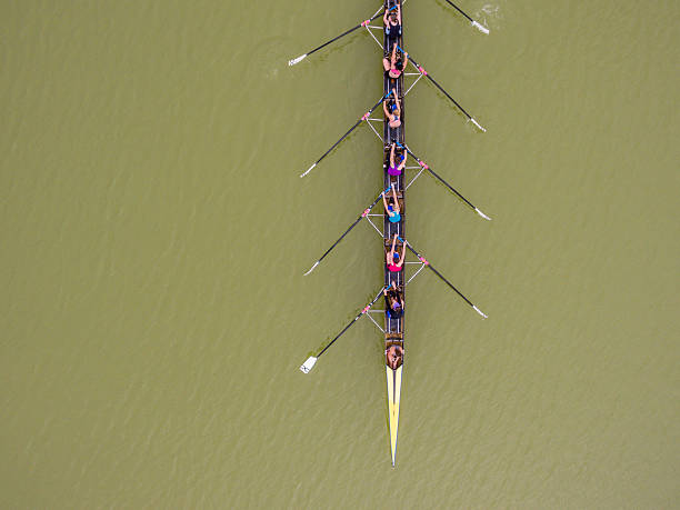 Eight rowing team boat aerial view Plovdiv, Bulgaria - June 5, 2016: Aerial view of eight women team boat training on the rowing channel in Plovdiv, Bulgaria. rowing stock pictures, royalty-free photos & images