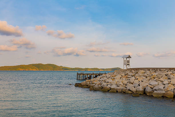 istock Lifeguard stand over rocky coastline 544462504