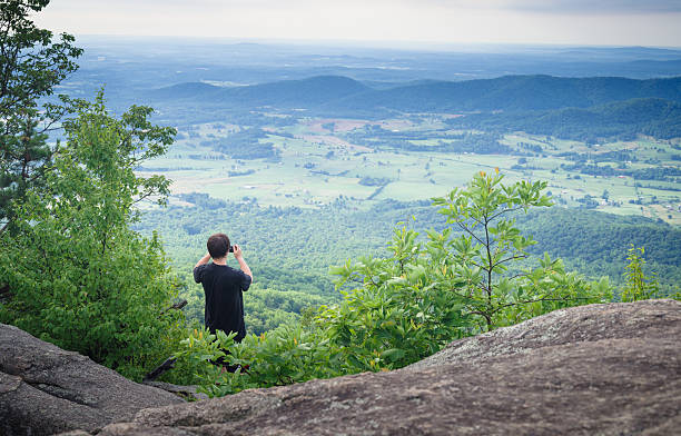 istock tourist taking pictures at mountain top 544465506