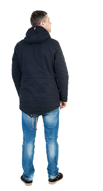 istock Back view of handsome man in winter jacket  looking up. 544466116