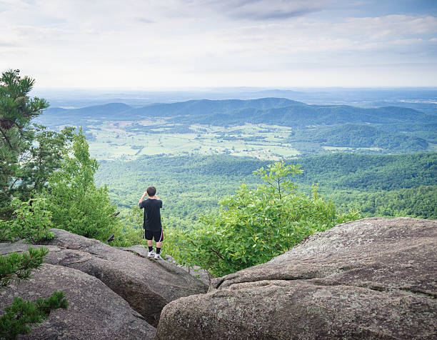 istock tourist taking pictures at mountain top 544466130