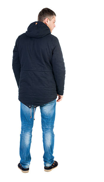 istock Back view of handsome man in winter jacket  looking up. 544466150