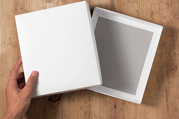 istock Hand opened cardboard box on wooden background 544466834