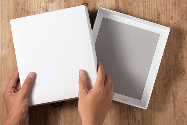istock Hand opened cardboard box on wooden background 544467248