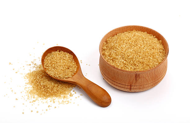 istock Scoop and bowl of brown cane sugar on white 544469008