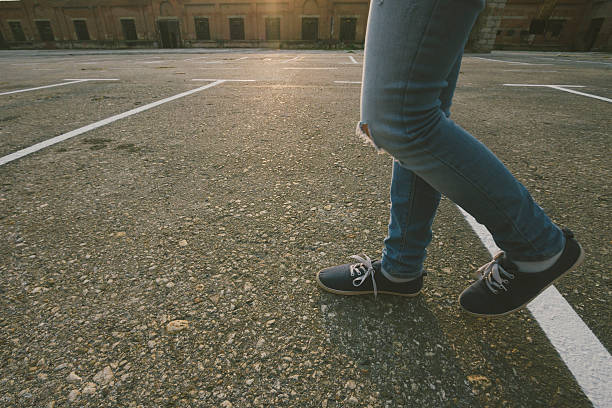 istock Young female walking over the parking lot 544469512