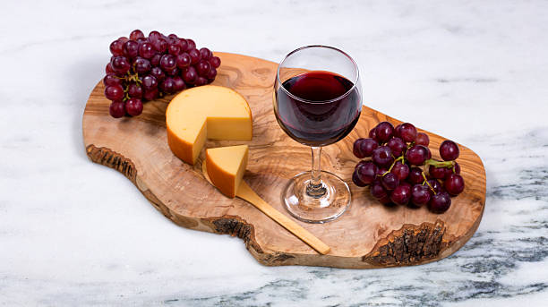 istock Red wine with gourmet cheese and grapes on wooden server 544472702