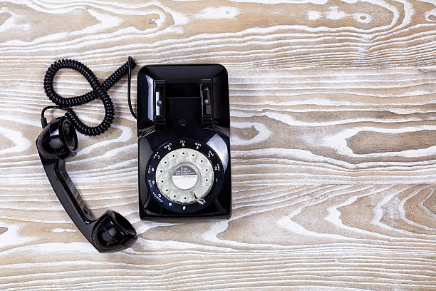 istock Retro telephone on faded wooden surface 544472854