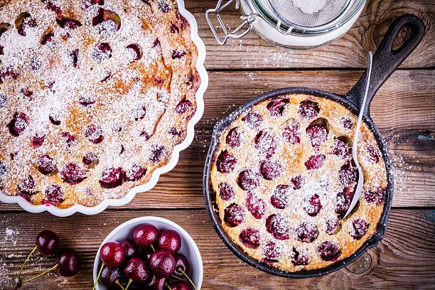 Clafoutis cherry pie on  wooden background Clafoutis cherry pie on rustic wooden background clafoutis stock pictures, royalty-free photos & images