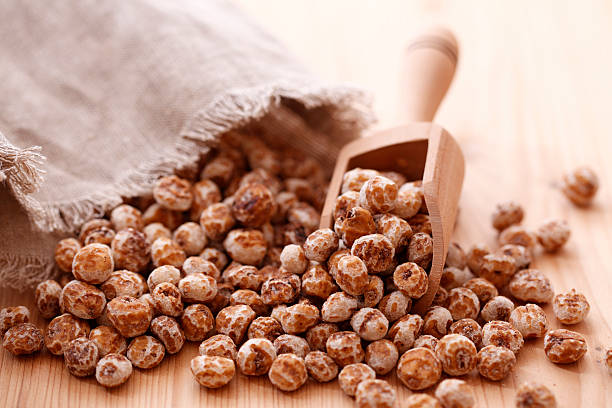 Tiger nuts Tiger nuts with wooden spoon sedge stock pictures, royalty-free photos & images