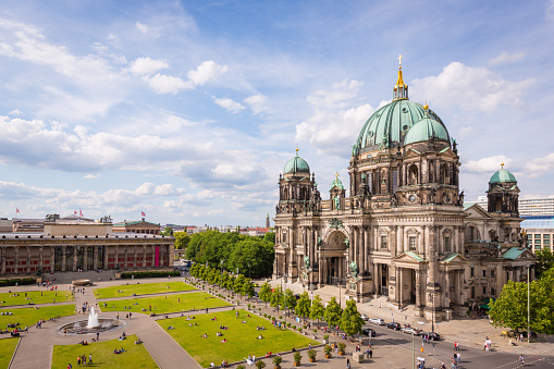 Aerial view down to with tourists and visitors crowded Lustgarten Park next to the famous Berliner Dom in Downtown Berlin, Germany.