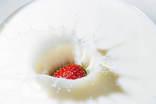 istock Red strawberry and white milk 544478588