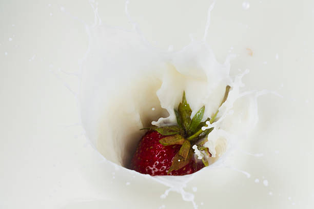 istock Red strawberry and white milk 544478840