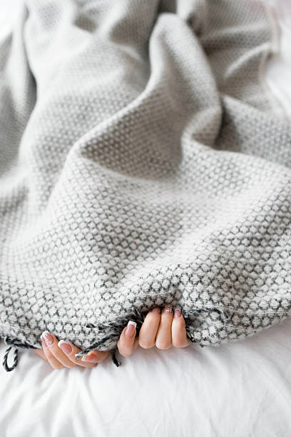 istock Woman hiding from the problems under gray blanket 544479850
