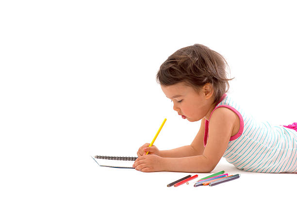 白に隔離された色とりどりの鉛筆で描く美しい少女 - schoolgirl little girls crayon human face ストックフォトと画像