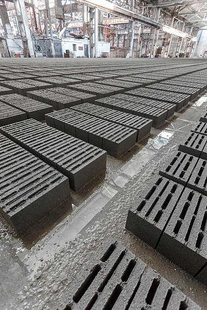 Stack of gray bricks Stack of bricks. Manufacturing of aerated concrete blocks. Manufacturing of cinder block. The plant manufactures building material. The plant produces a cinder block. Cinder block-building material. kerbstone stock pictures, royalty-free photos & images