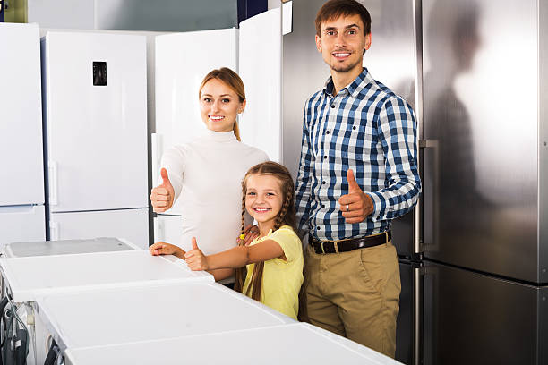 family choosing refrigerator in store - three different refrigerators imagens e fotografias de stock