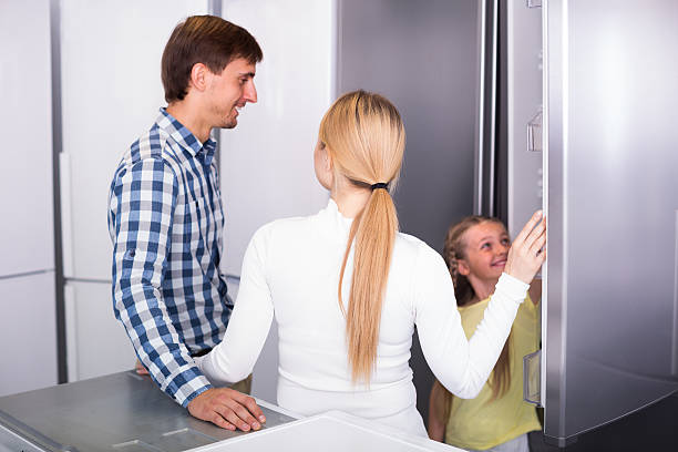 family selecting refrigerator - three different refrigerators imagens e fotografias de stock