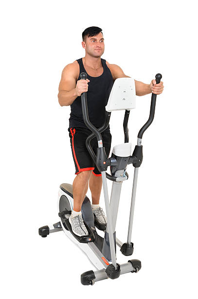 istock young man doing exercises on elliptical cross trainer 544485234