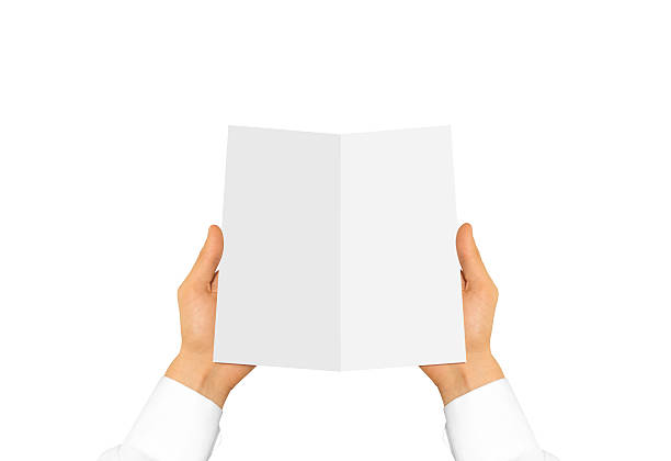 istock Hand in white shirt sleeve holding blank leaflet 544485358