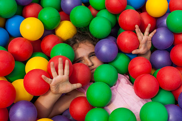 istock Girl having fun playing in a colorful plastic ball pool 544486268