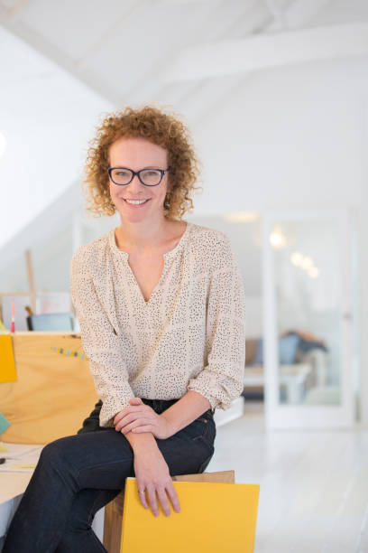 istock Portrait of laughing office worker holding file 544487961