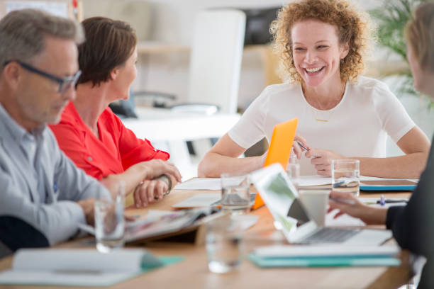 Group of female office workers have a good time while working together in a pleasant atmosphere at workplace. Business, office, job