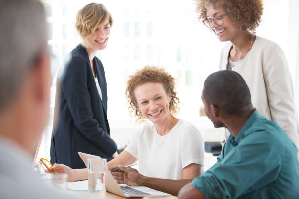 istock Group of office workers talking at desk 544488271