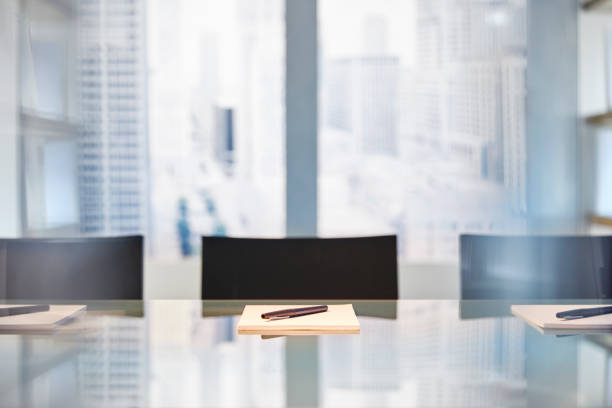 istock Part of modern conference room with table chairs, notepads and pens 544488375