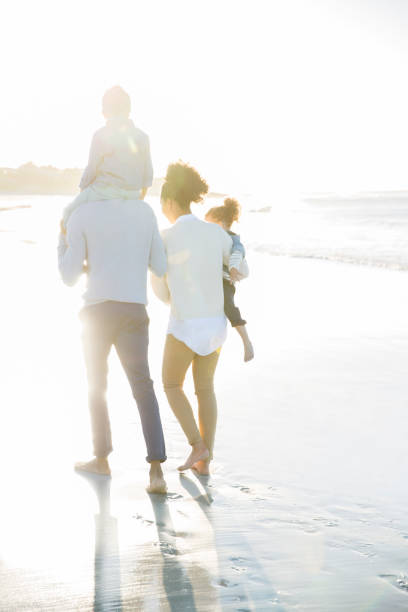 istock Family walking on beach in sunlight 544489183