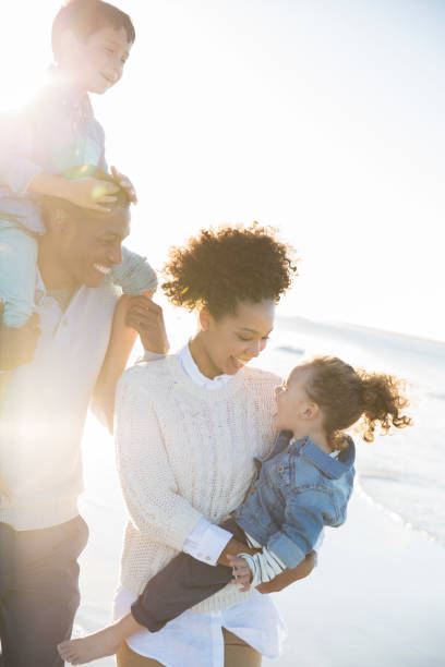 istock Happy family having fun on beach 544489371