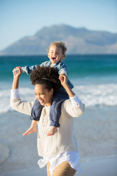 istock Mother and daughter playing on beach 544489423
