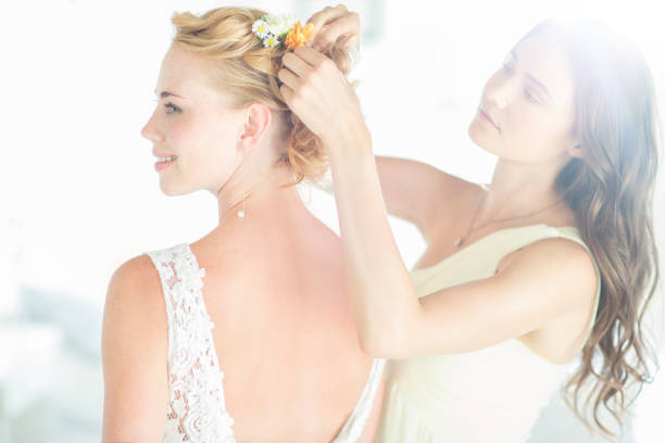 portrait of a luxurious bride in boudoir style near a mirror with reflection. Preparing the bride for the wedding in the morning in a white robe.