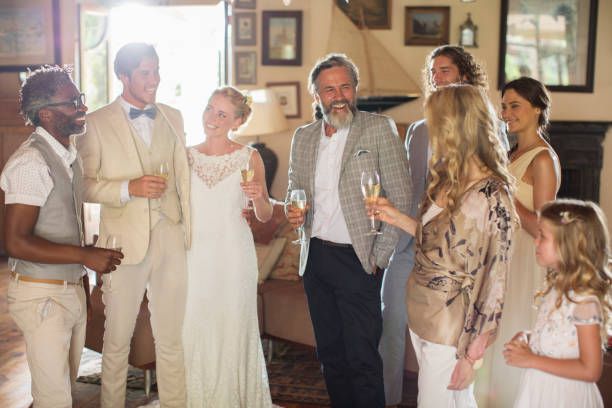 istock Young couple with guests and champagne flutes at wedding reception 544490165