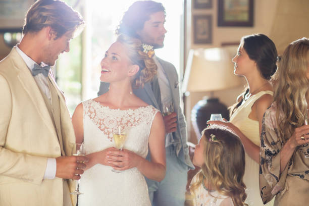istock Young couple with guests and champagne flutes at wedding reception 544490175