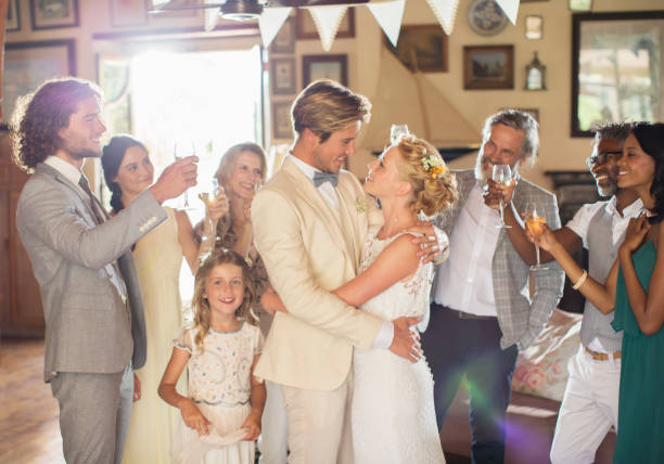 istock Bridegroom embracing bride during wedding reception in domestic room 544490555