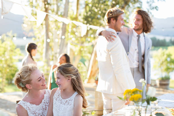 istock Bride talking to bridesmaid during wedding reception in domestic garden 544490565